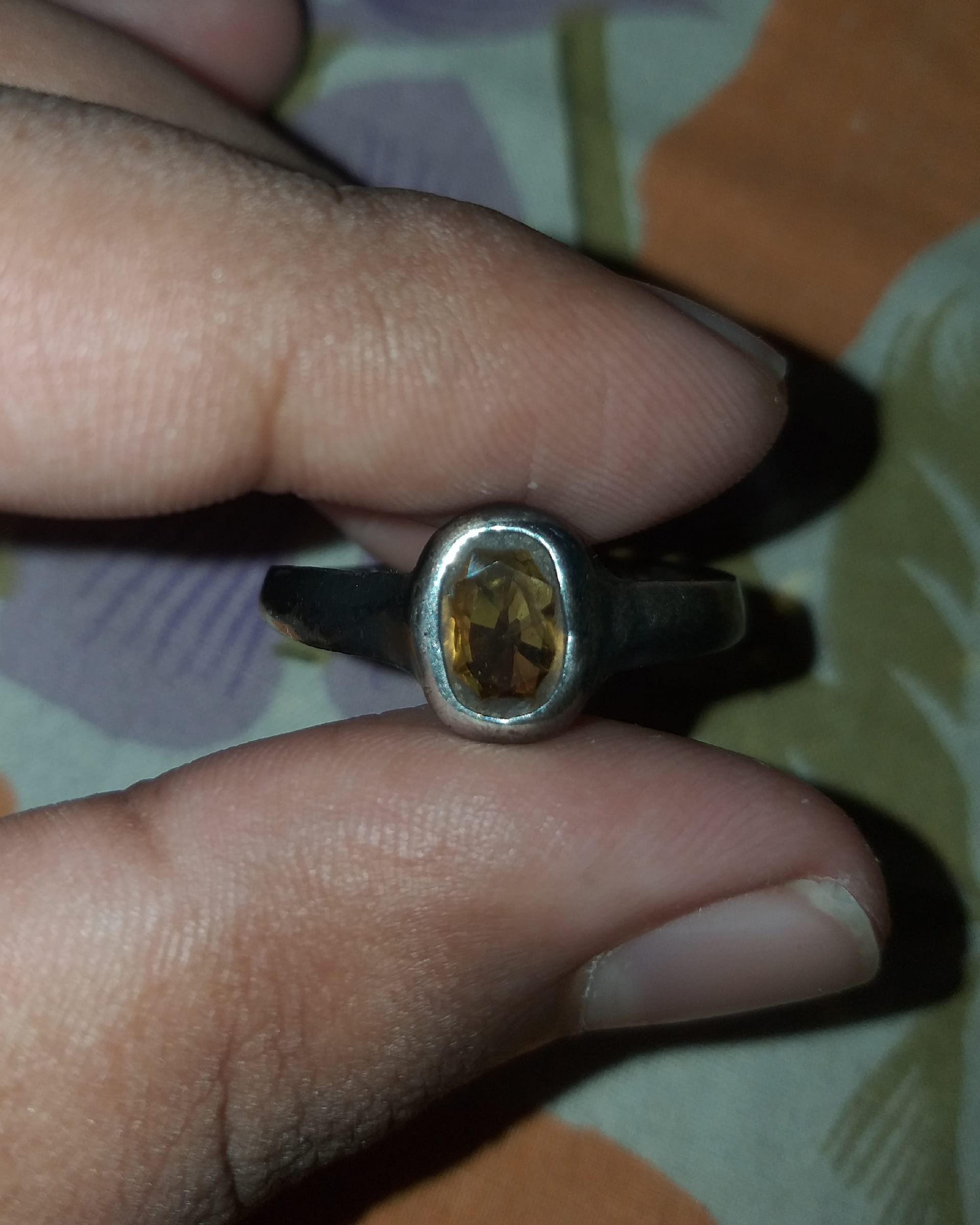 Large faceted yellow sapphire ring with a diamond-set yellow-gold architectural gallery.